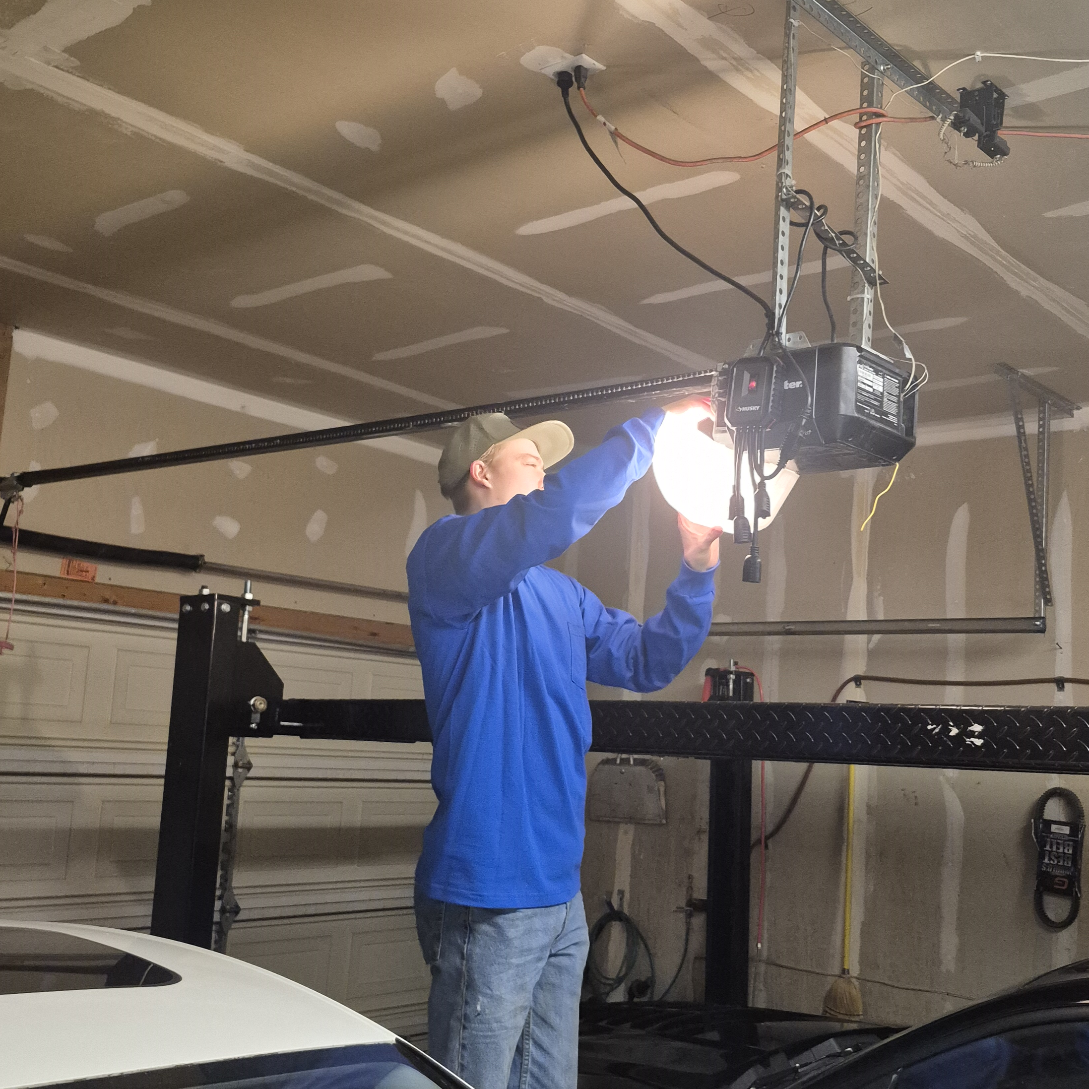Expert garage door technician performing garage spring repair in West Jordan, Utah
