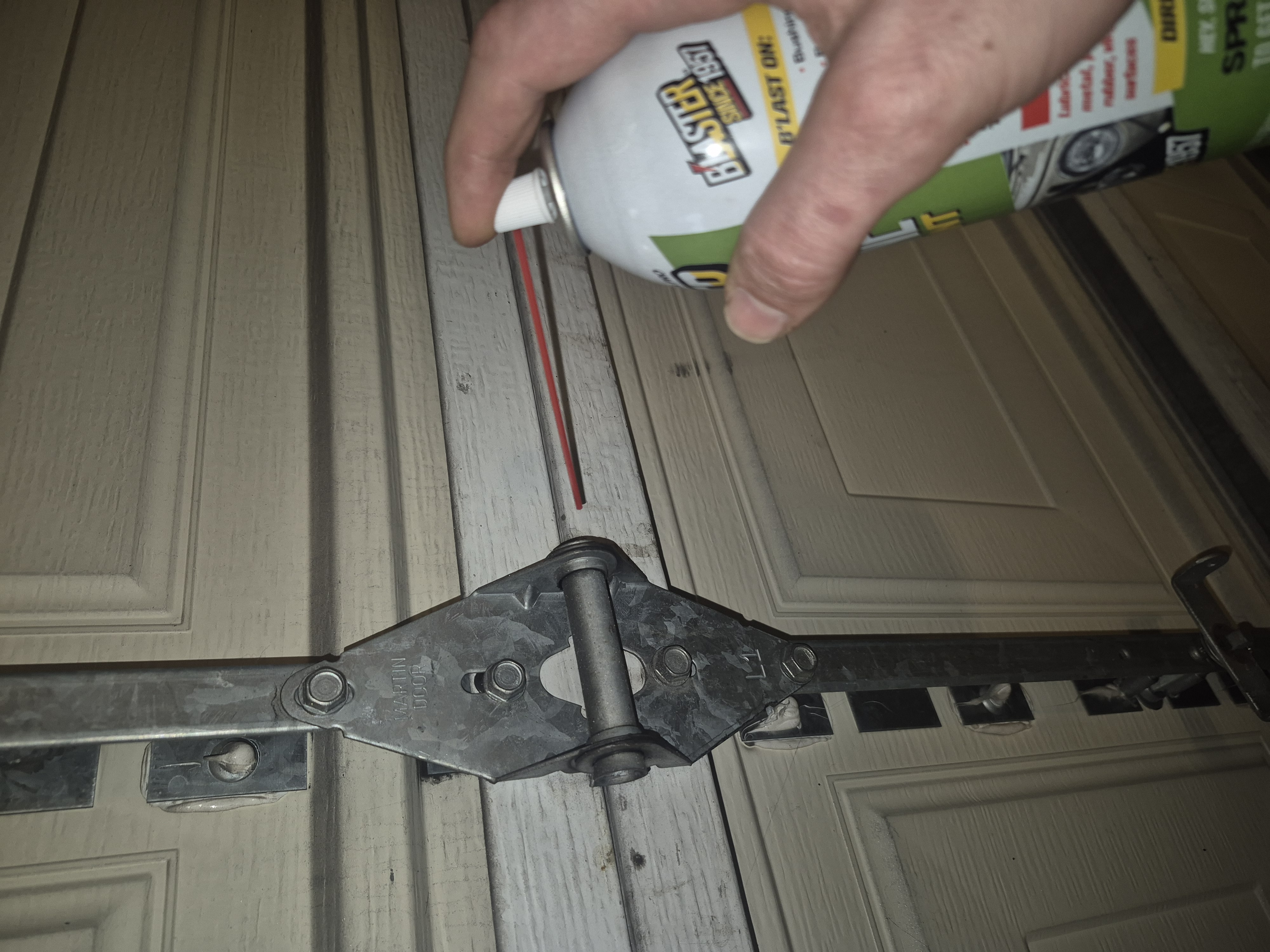 Applying lubrication to garage hardware