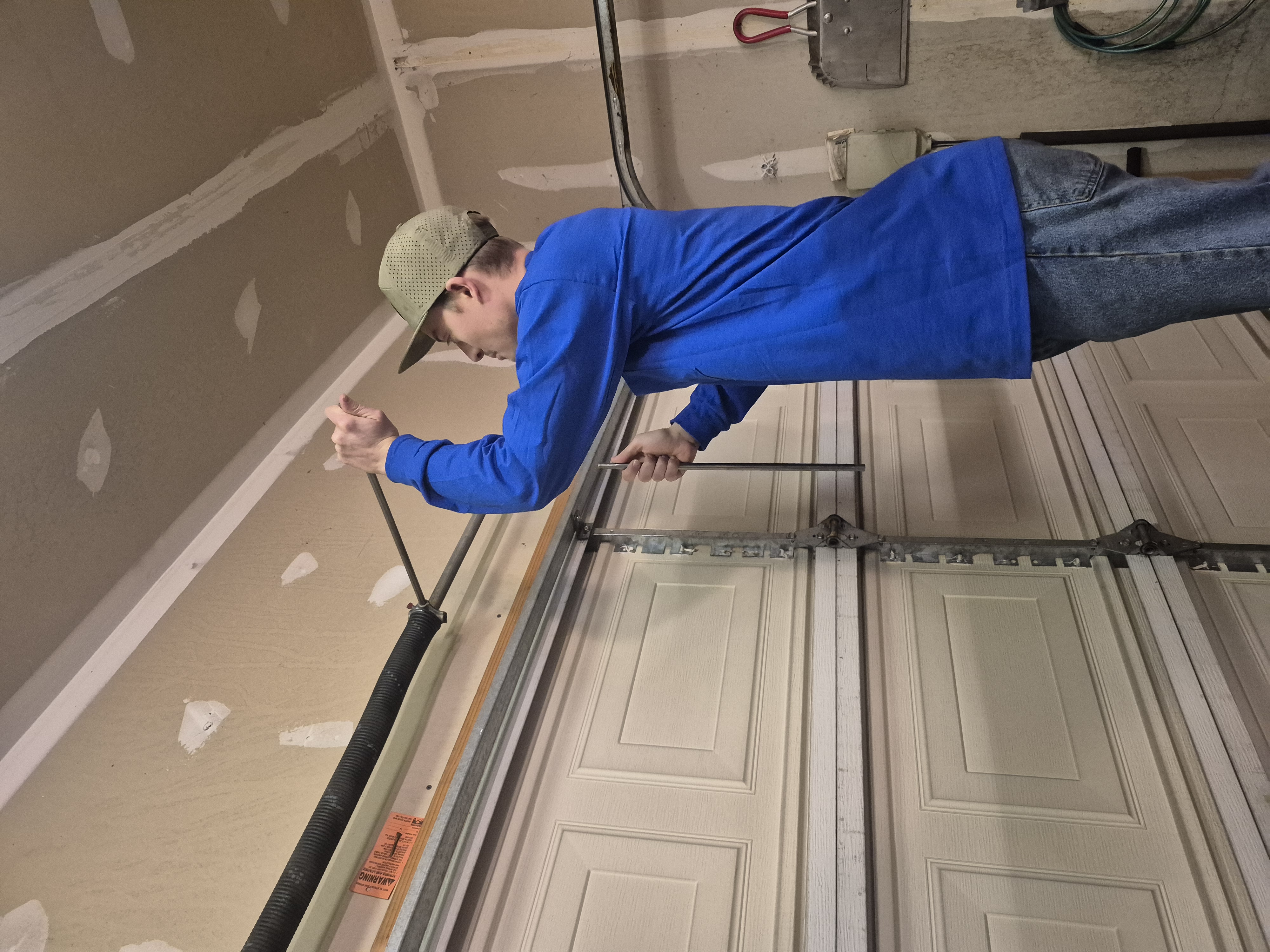 Technician working on garage door hardware